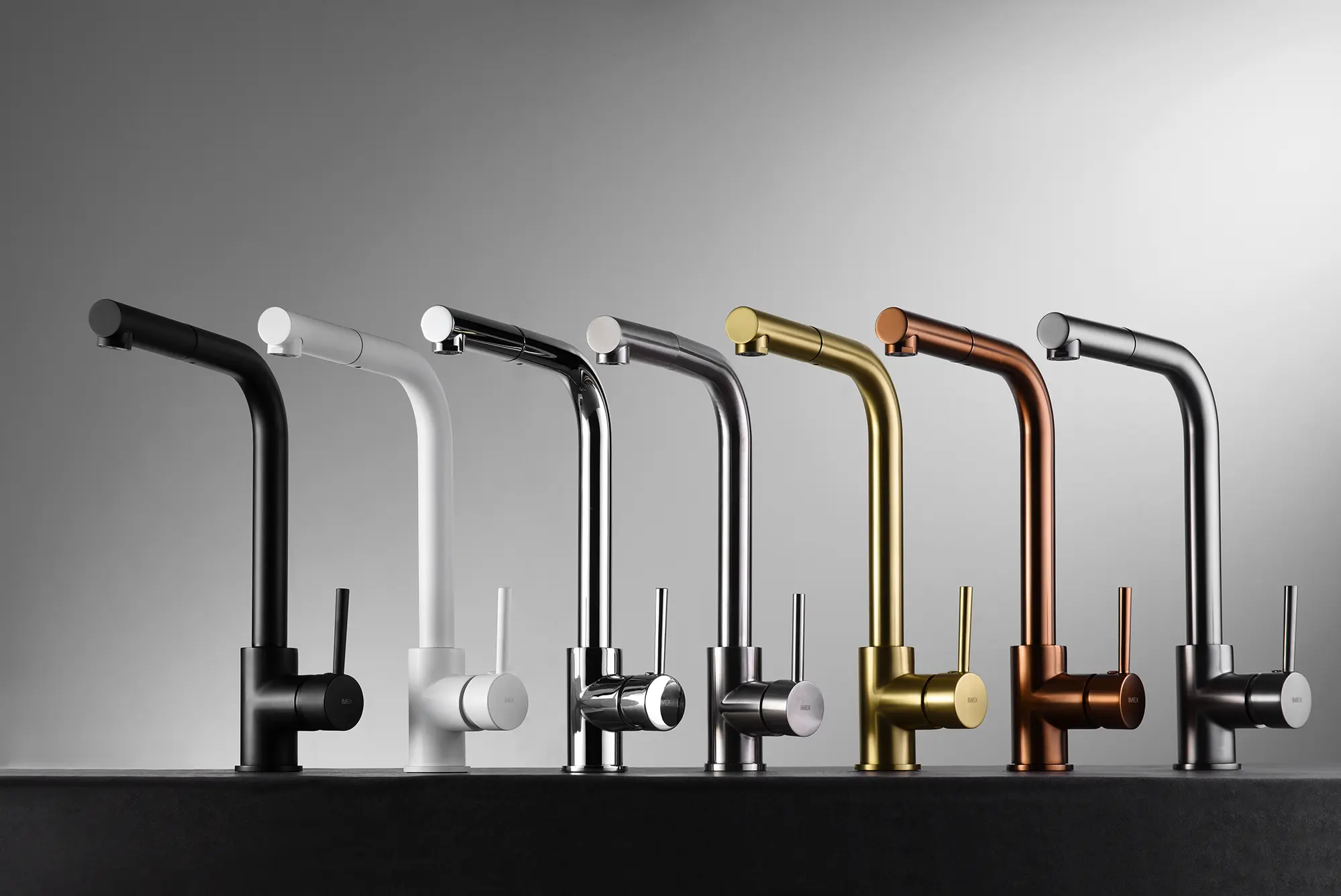 Line of modern faucets in various finishes, including black, white, chrome, silver, gold, and copper